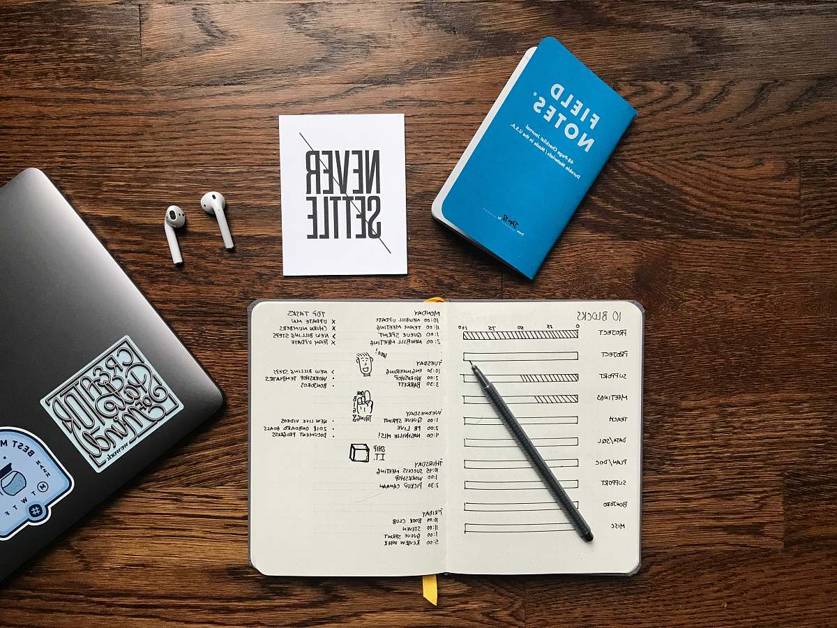 business card Apple AirPods near MacBook text